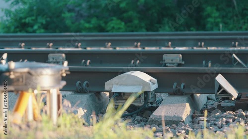 Infrared Train Brake Temperature Sensor Mounted on Railway Track | Slow Motion Close-Up Shot with Subtle Parallax Camera Movement | Railroad Safety Monitoring Technology
