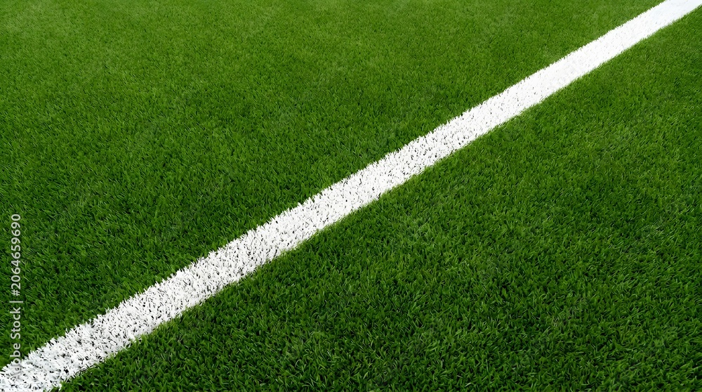 Fototapeta premium Green soccer field with white boundary line