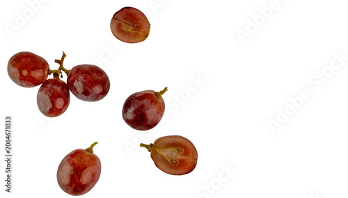 Flying Red Grapes and Slices on White Background