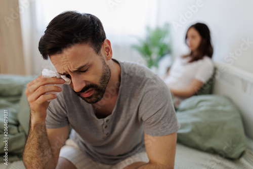 Couple sitting on bed during a difficult moment