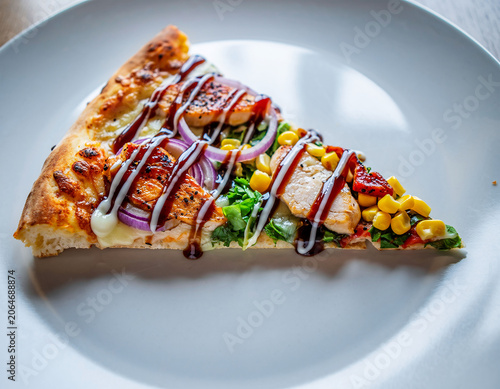 Barbecue Pizza Slice with Sauce and Corn Served on White Plate