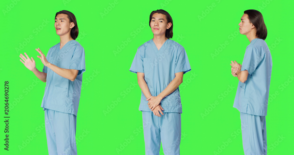 Obraz premium Male nurse nodding on camera and saying yes, showing approval and agreement gesture over green screen backdrop, with pleased medical assistant doing good symbol, agreeing with something.