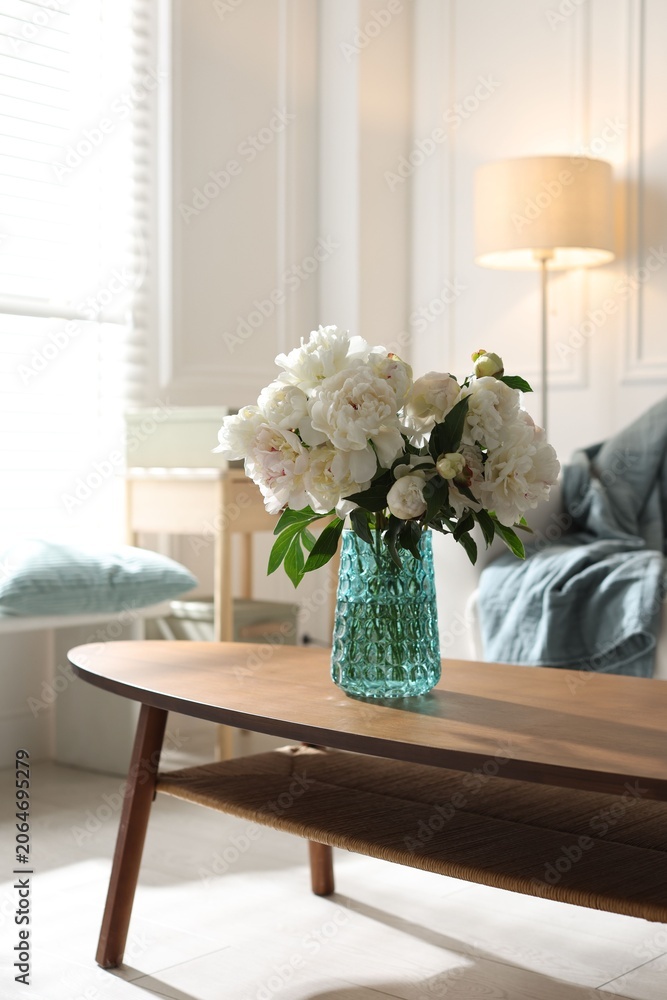 Fototapeta premium Bouquet of beautiful peony flowers on wooden table at home