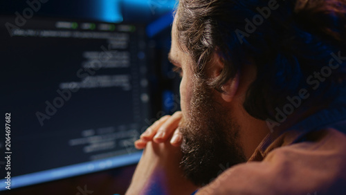 Schilderij op canvas Programmer in home office concentrating on finding bugs while doing coding on computer, extreme close-up shot, iT admin frowning while looking at screen, confused by errors in lines of code