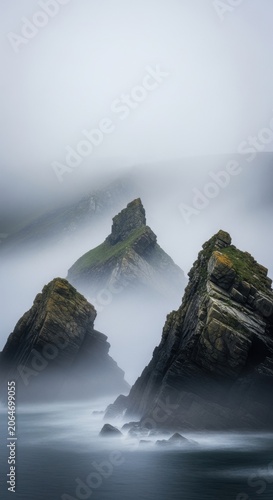 Misty Mountains Emerging from Foggy Ocean Waters.