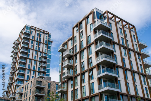 Photography Modern residential apartment buildings with balconies under blue sky in urban se