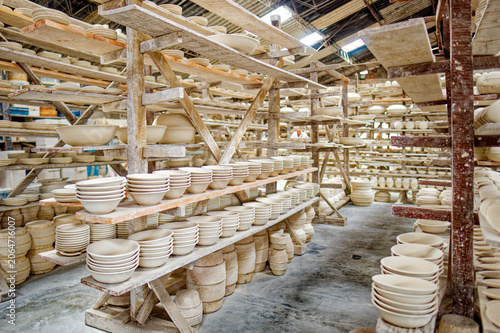 Ceramic dishes being dried on shelves in a traditional ceramic warehouse in the city of Carmen de Vilboral, Colombia.