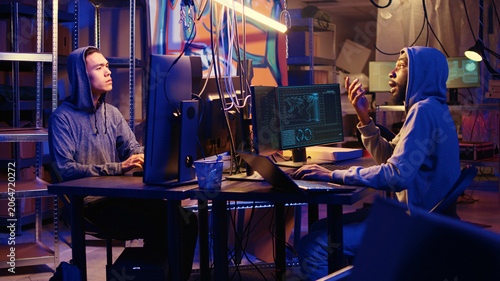Obraz na plátně Hackers brainstorming ways to go undetectable by antivirus software installed on systems and successfully trick firewalls, discussing methods of developing zero day exploit in secret bunker