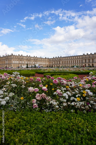 Fotografie Colorful Flower Garden Parterre with Palace of Versailles Facade in Background,
