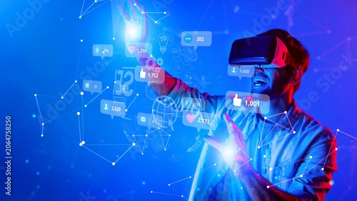 Fotografi A man appears immersed in a virtual reality experience, interacting with digital elements and icons, showcasing the excitement of modern technology and virtual exploration