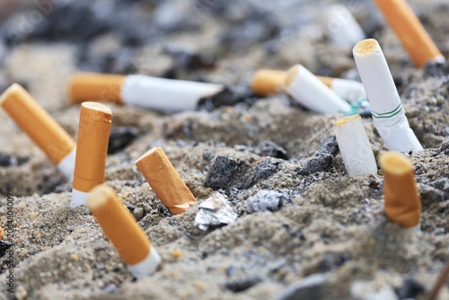 Photography Stop smoking concept with cigarette butts discarded in sand