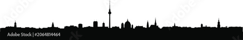 Valokuva Silhouette of a city skyline with prominent tall building and church spires at d