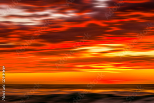 Obraz na plátně Motion blur sunrise over ocean,created in camera using slow shutter speed photography along the Sydney coastline, Australia
