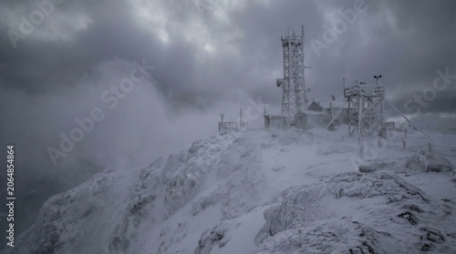 Frozen Communication Tower on Stormy Mountain Peak