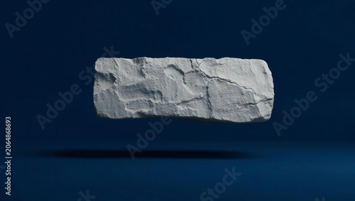 Close-up of a textured gray brick floating against a dark background, minimalistic and modern style