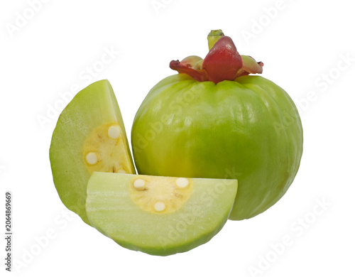 Fresh green Garcinia atroviridis fruit and sliced pieces isolated on white background