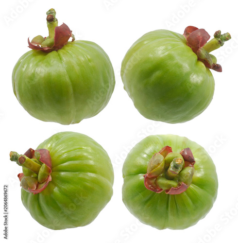 Fresh green Garcinia atroviridis fruit and sliced pieces isolated on white background