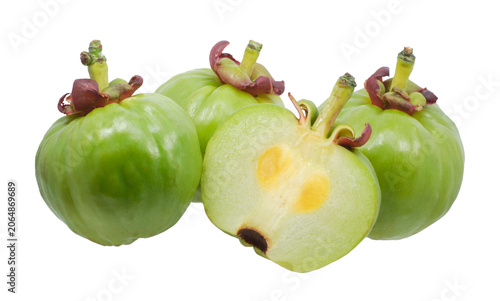 Fresh green Garcinia atroviridis fruit and sliced pieces isolated on white background