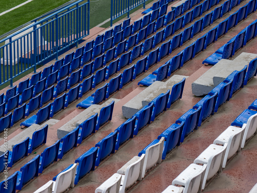 Fototapeta premium Empty blue stadium seats and railings