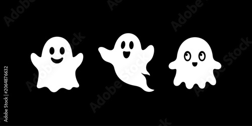 Fotografie Three cute white ghosts smiling on a black background