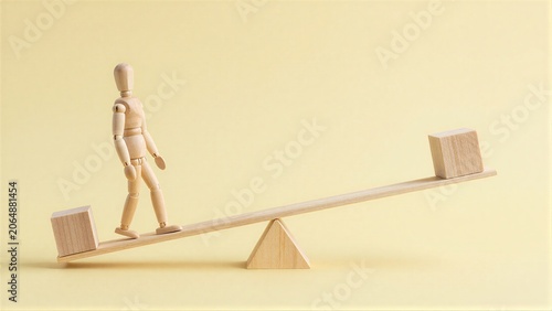 Wooden figure stands on seesaw, balancing two blocks against a soft yellow background.