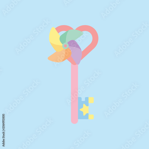 A pastel colored heart shaped key with a spinning toy top