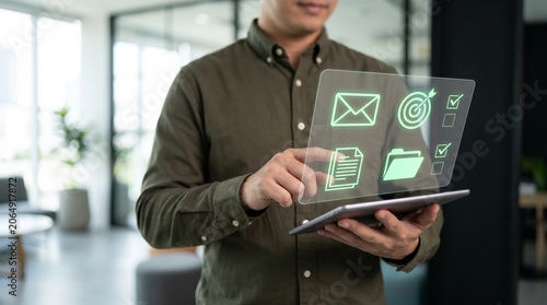 Professional worker using tablet with virtual dashboard showing email and folder icons for digital document management and project task tracking in office environment