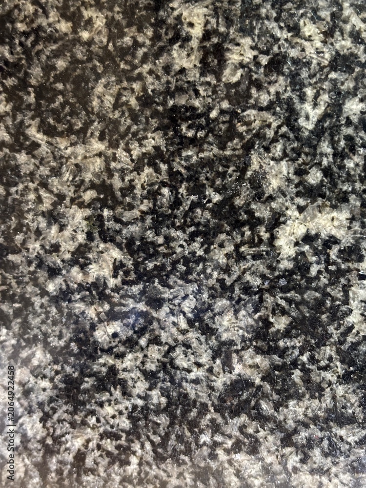Fototapeta premium Abstract natural dark stone background featuring grey and white crystalline structures.