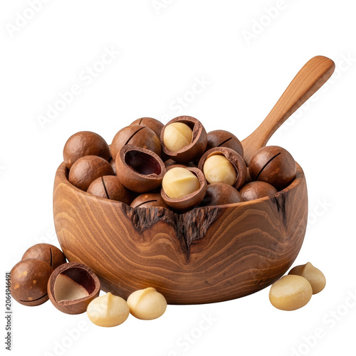 Raw macadamia nuts in a rustic wooden bowl with a wooden spoon as cut out PNG
