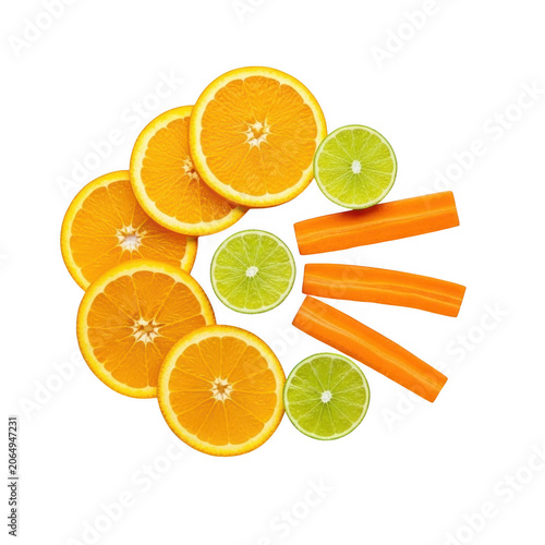 Slices of orange and lime with carrot sticks as transparent object