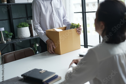 Canvas Print Business man sending resignation letter and packing Stuff Resign Depress or carrying business cardboard box Change of job or fired from company resign