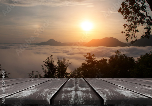 Empty old wooden table top with beautiful sea of fog and sunrise background.