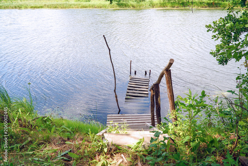 Wooden pier on a calm river bank