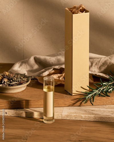 Gold cosmetic ampoule product mockup on wooden table