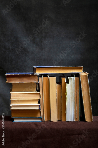 A stack of old books and notebooks on the table