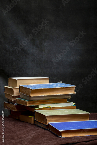 A stack of old books and notebooks on the table