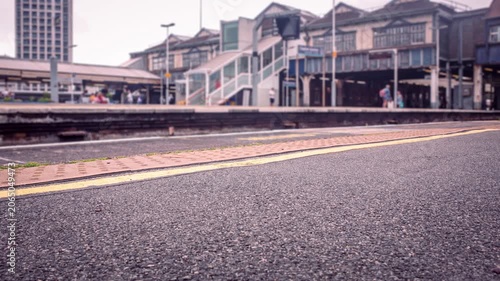 LONDON - timelapse busy train station platform with negative space in foreground