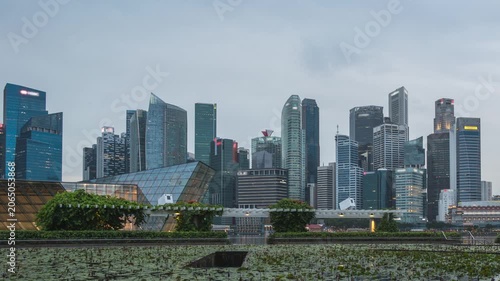 Singapore time lapse city skyline day to night sunset at Marina Bay waterfront business district