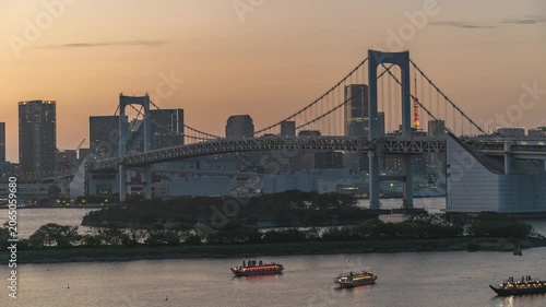 Tokyo Japan time lapse city skyline day to night at Odaiba Rainbow Bridge