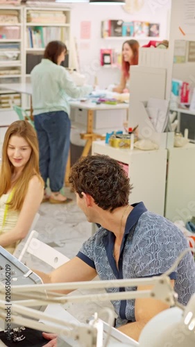 Fashion designers working together in sewing workshop