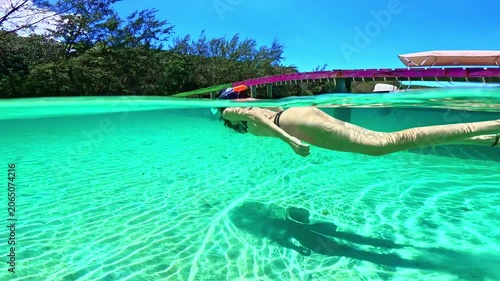 Woman snorkeling underwater in turquoise caribbean sea