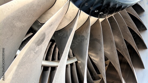 Detailed perspective of a commercial aircraft turbofan engine fan blade, highlighting the power, precision manufacturing, and aviation technology