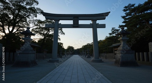 A stone torii gate frames a long, symmetrical path at dusk