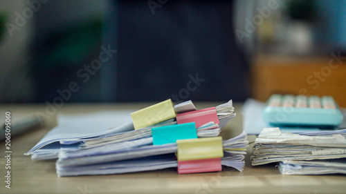 Fotografi Stacks of papers hold colorful clips