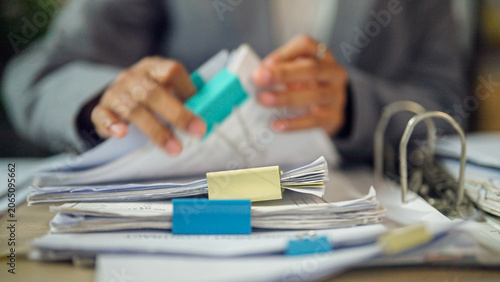 Fotografie Hands organize papers with colorful clips and binders