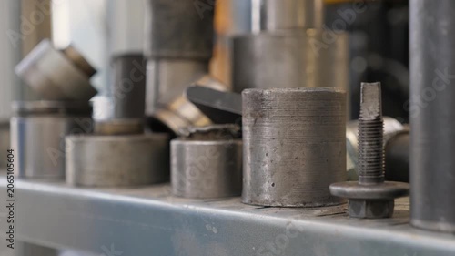 Close-up of a shelf with silent blocks at a car service station, various tools and accessories. A modern auto repair shop. Replacement of the silent block. Stable image.