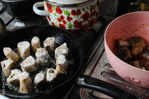 Frying fish in a pan with flour coating