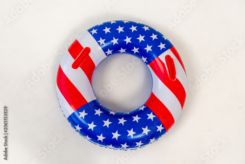 American Flag pool float. Top view of ring circle on white background. Summer vacation concept. Vacation in USA concept. 4th of July pool party. High quality photo