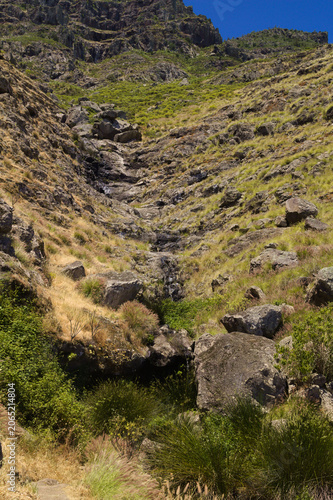 Views along the scenic hiking trail ascending from San Pedro,descending from the high threshing ground Era de Berbique toward the coastal village of Puerto de las Nieves in northwest Gran Canaria, Can