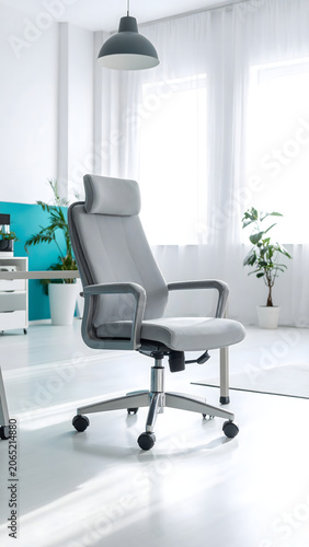 Creative design studio with a light gray ergonomic office chair featuring a soft lumbar cushion, set in an airy modern workspace. 